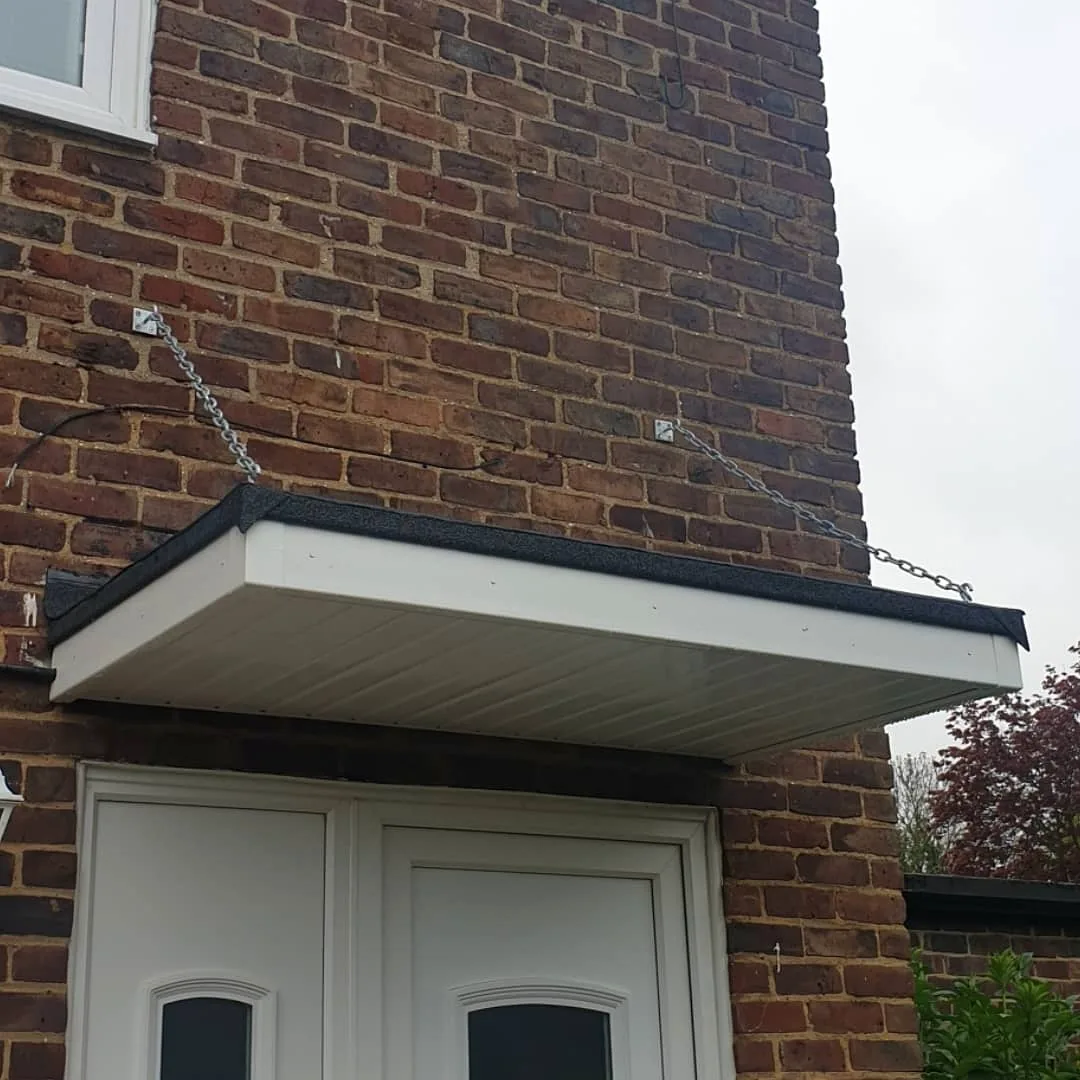 Completed flat entrance canopy with white soffit and dark fascia