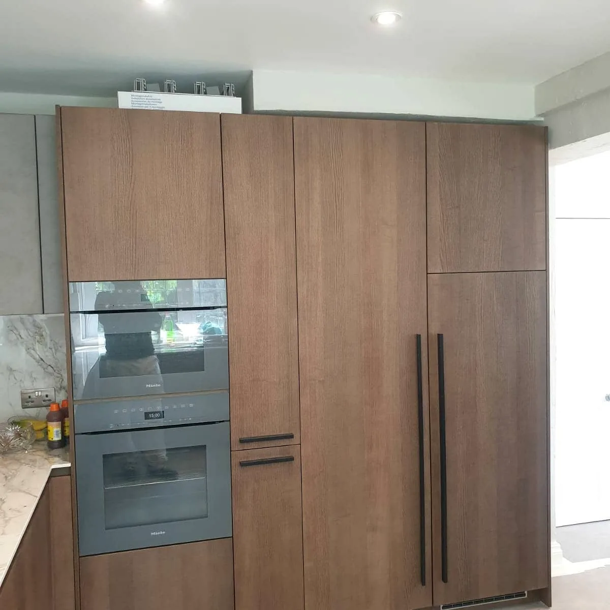 Full-height wood kitchen cabinets with integrated double oven